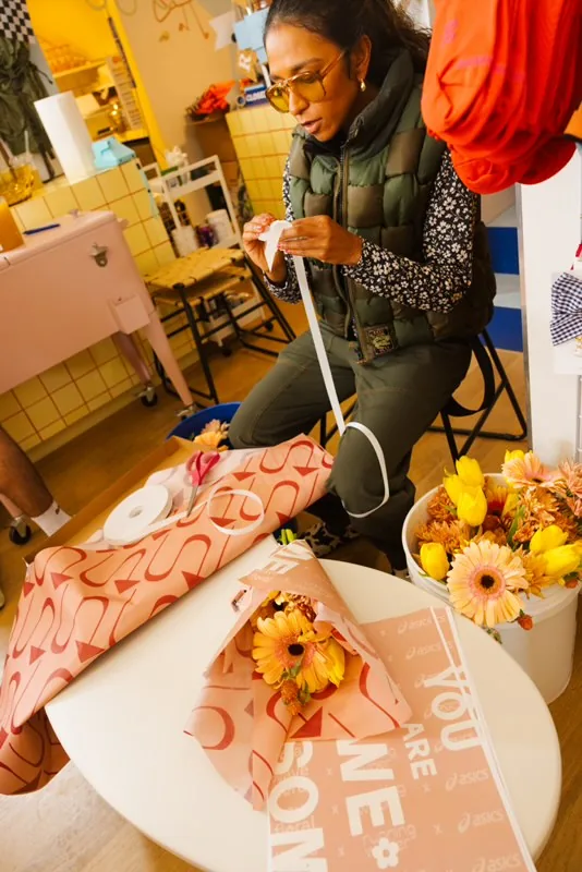 Wrapping gerbera and tulip bouquets for finishers at the Asics San Francisco Marathon activation