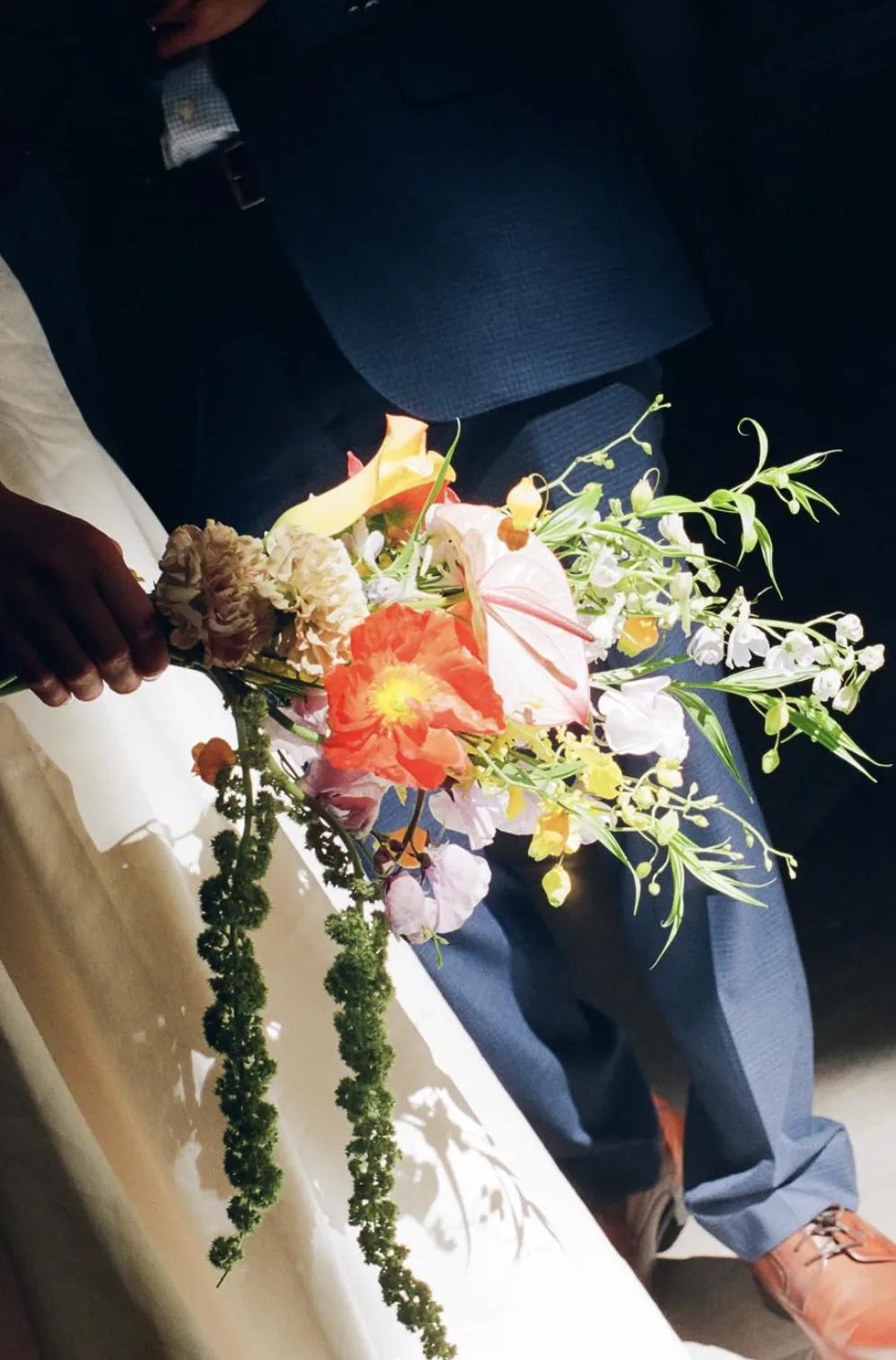 Cascading bridal bouquet with poppy, calla lily and trailing green amaranthus