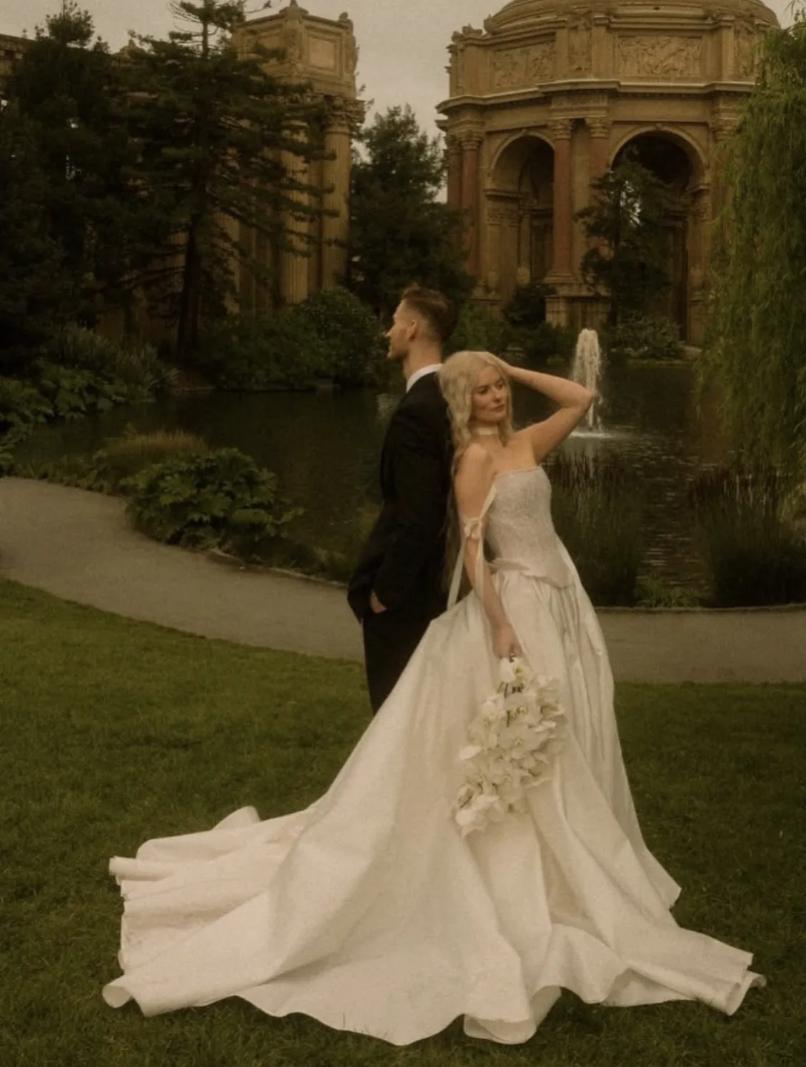 Bride at the Palace of Fine Arts with a cascading white orchid bouquet