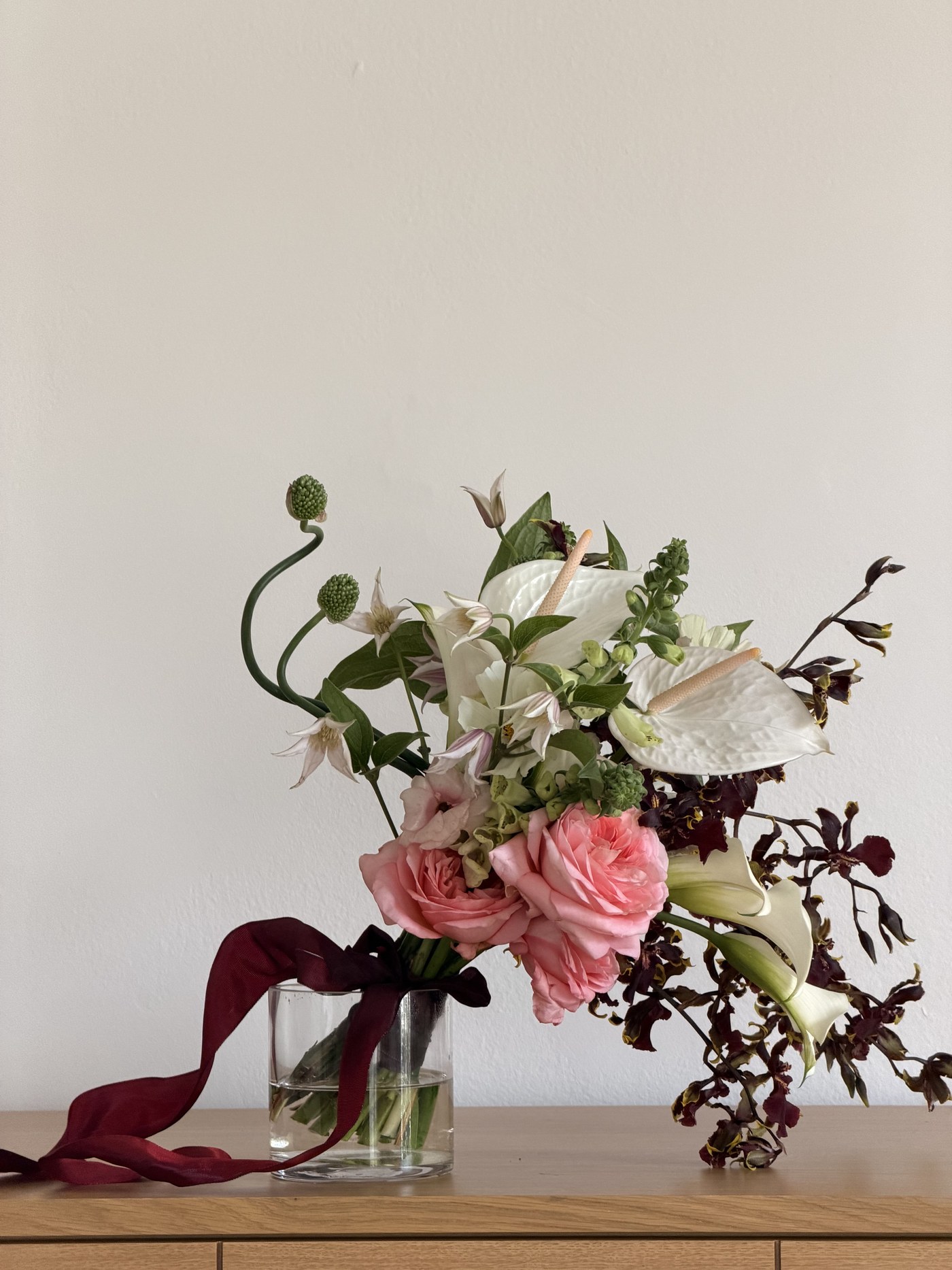 Large blush and white arrangement with anthurium, garden roses and orchid