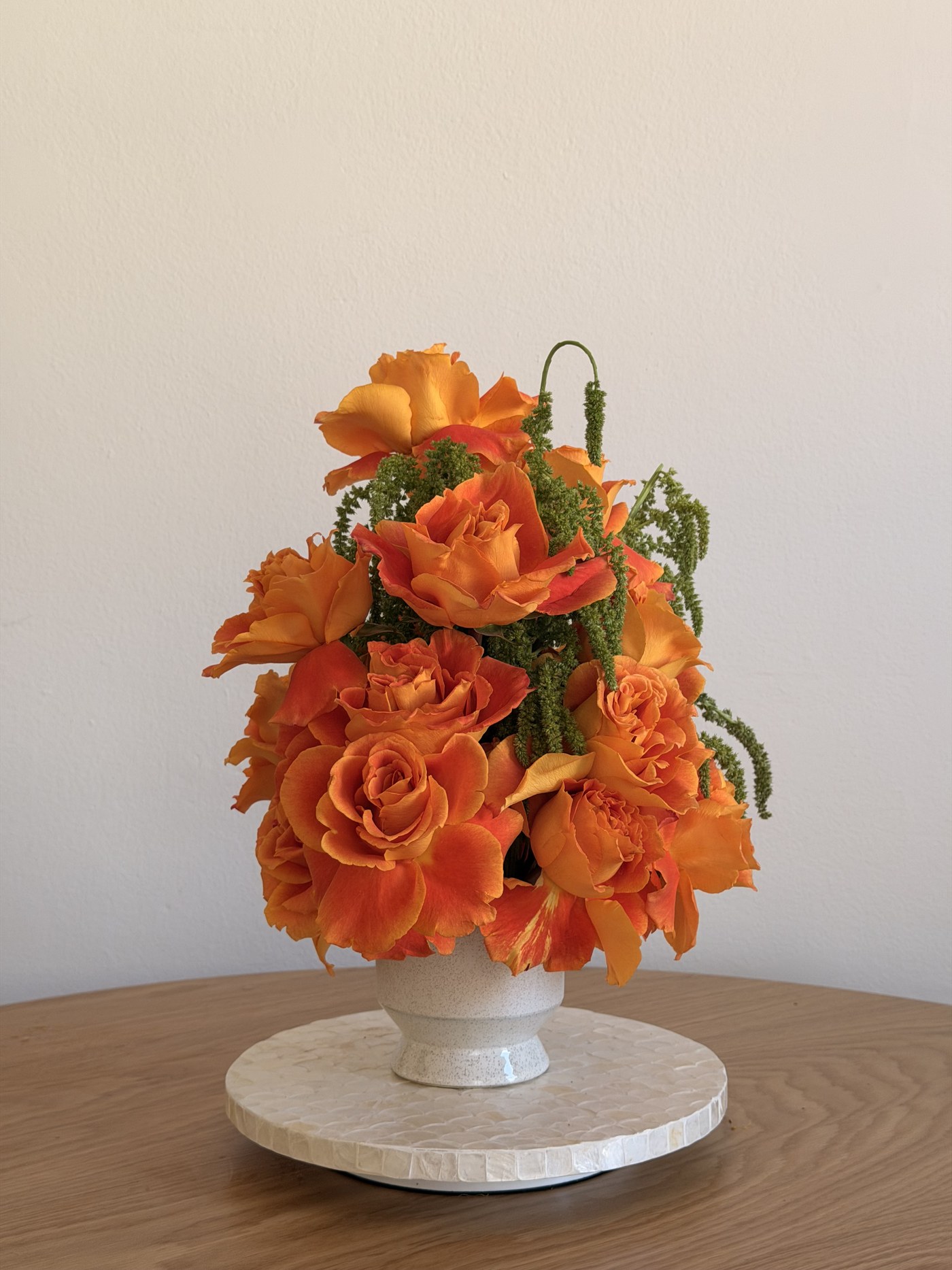 Small monochrome orange garden rose arrangement with green amaranthus